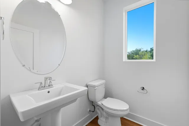 a white toilet sitting next to a bathroom sink
