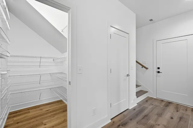 a view of walk in closet with empty racks