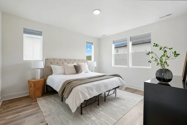 a bedroom with bed and a window