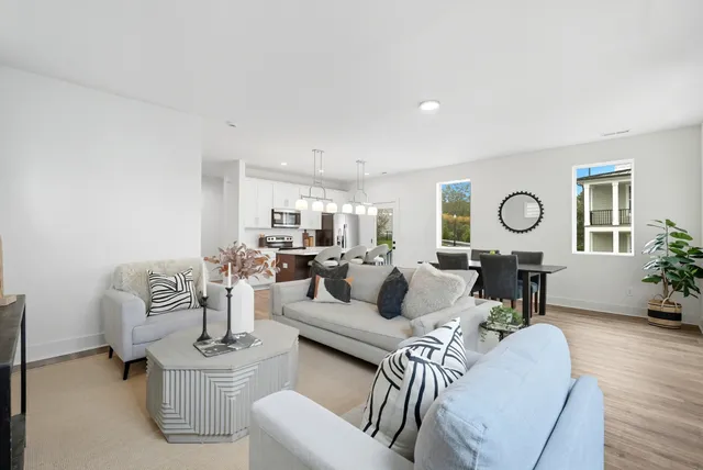 a living room with furniture a chandelier a mirror and a table