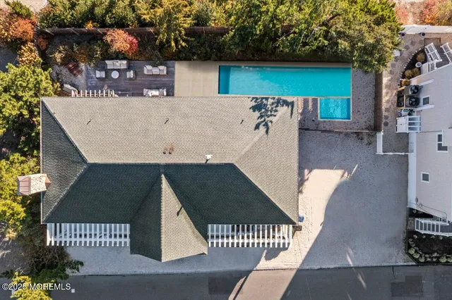 a front view of a house with yard and trees