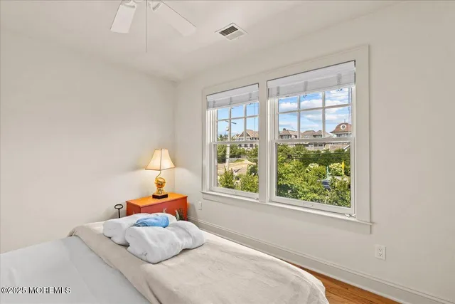 a bathroom with a granite countertop toilet sink and mirror
