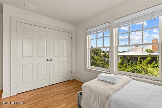 a view of a hallway with wooden floor and windows