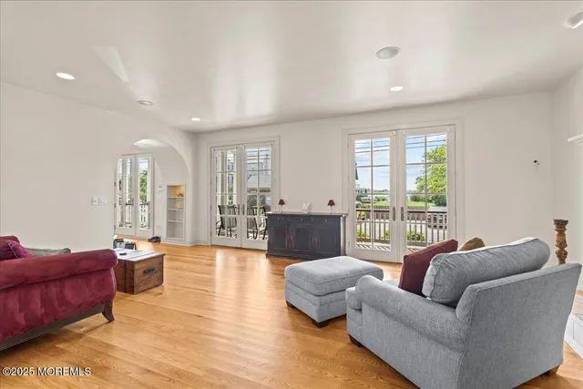 a view of a dining room with furniture a chandelier and wooden floor