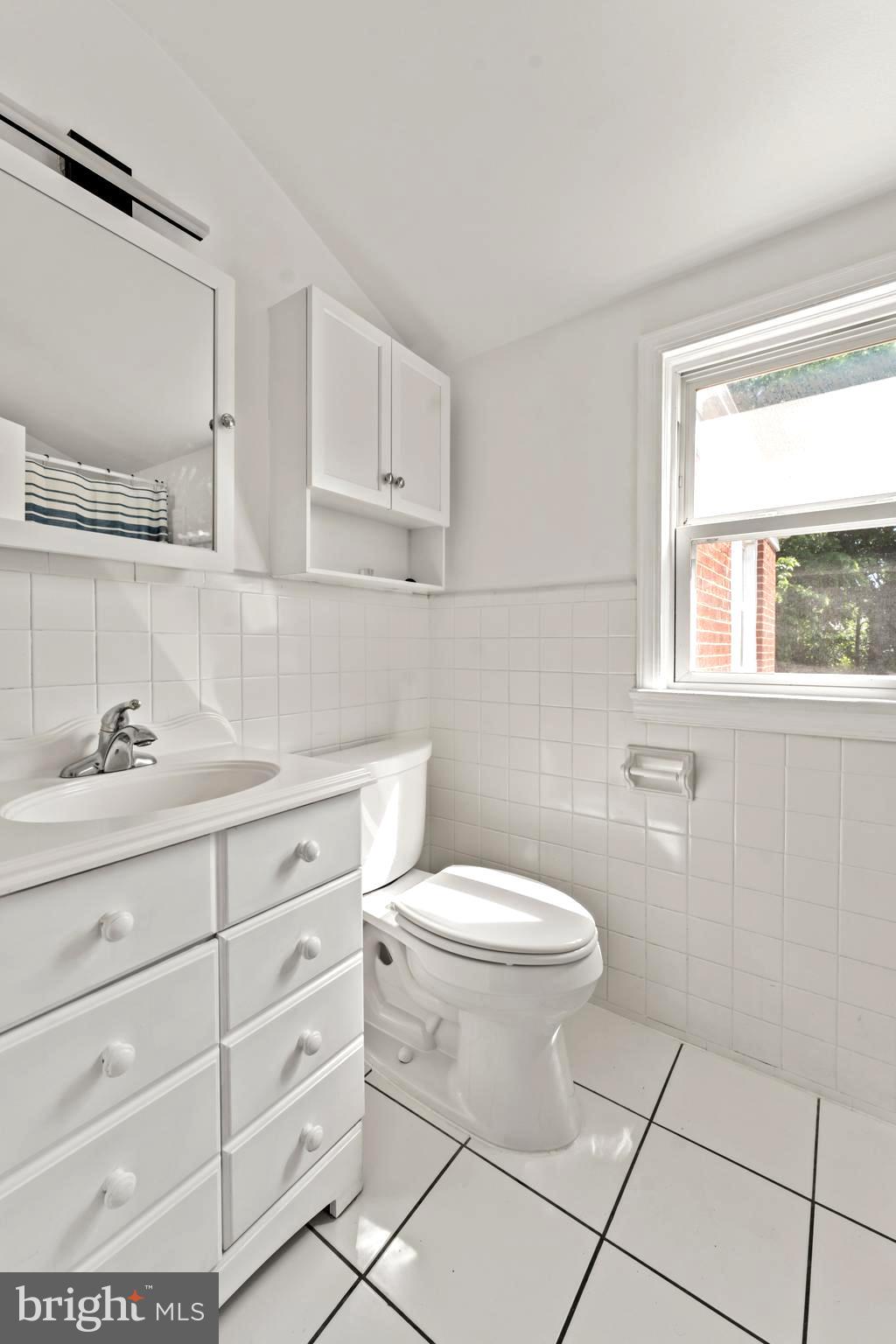9307 Biltmore Drive Silver Spring, MD 20901 - Photo 13 of 33 a bathroom with a sink a toilet and a mirror