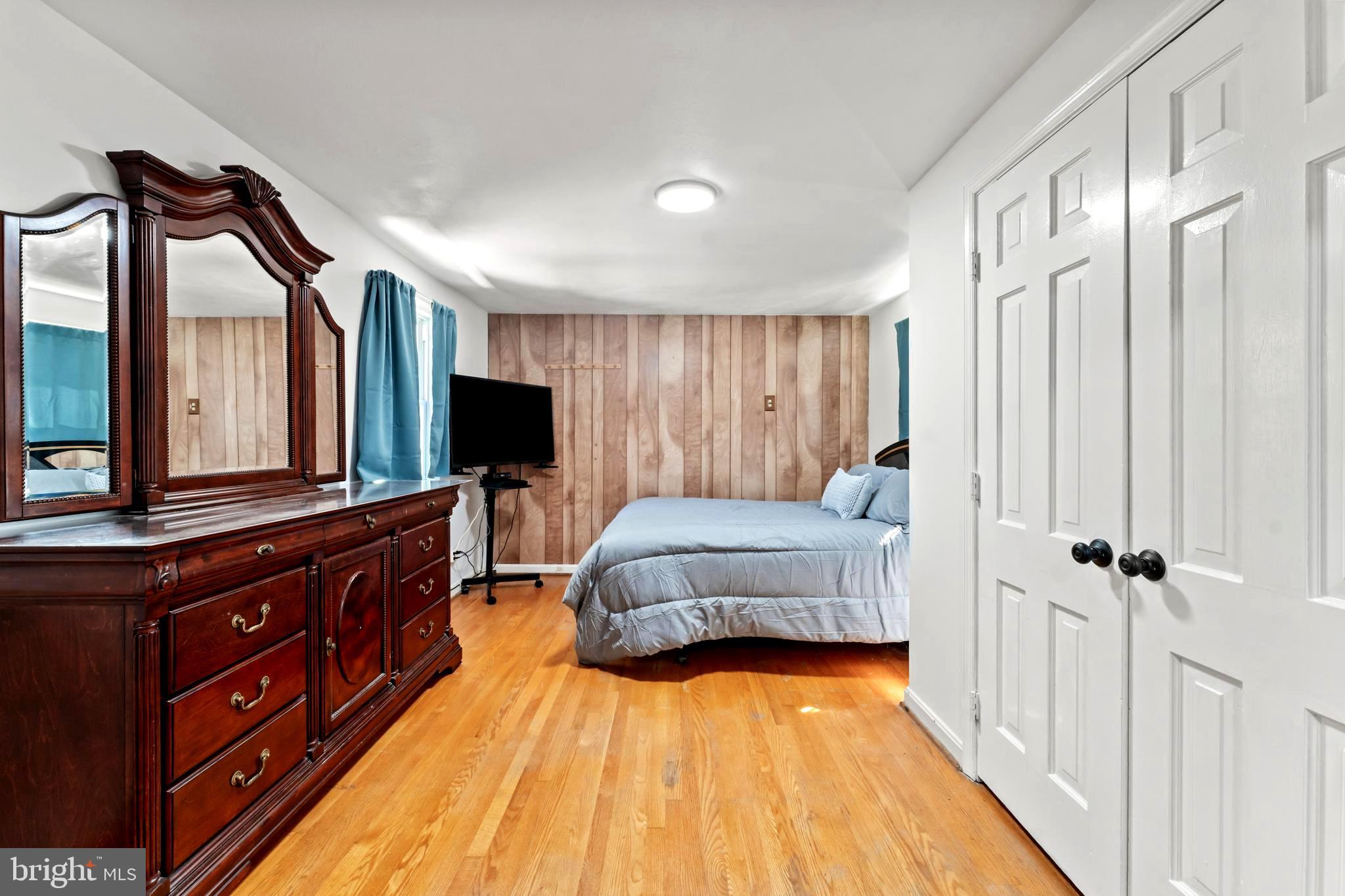9307 Biltmore Drive Silver Spring, MD 20901 - Photo 14 of 33 a bedroom with a bed and a flat tv screen on dresser