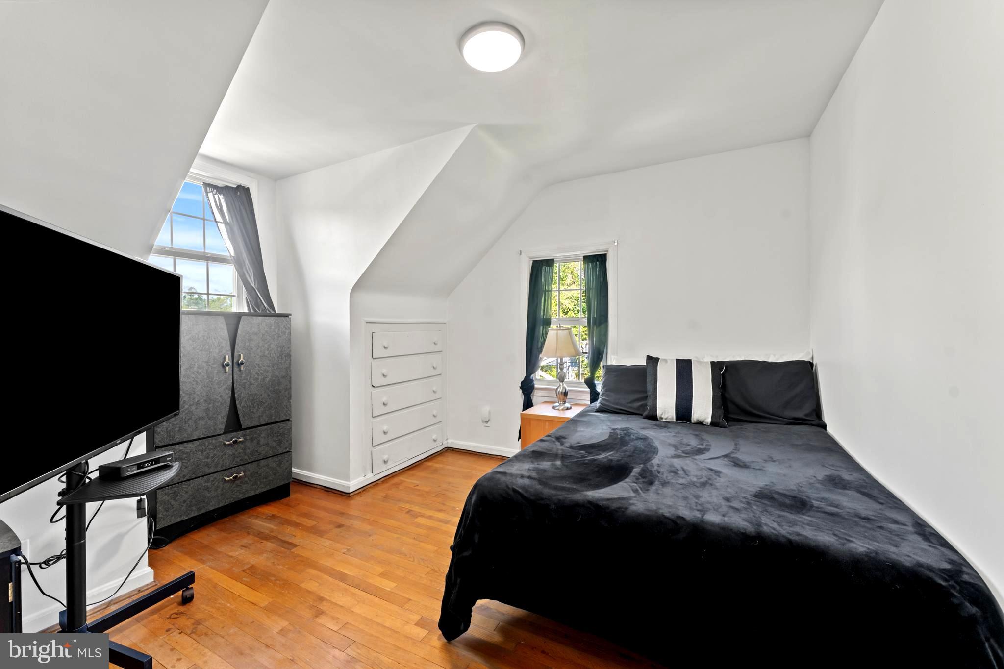 9307 Biltmore Drive Silver Spring, MD 20901 - Photo 16 of 33 a bedroom with a bed and a flat screen tv