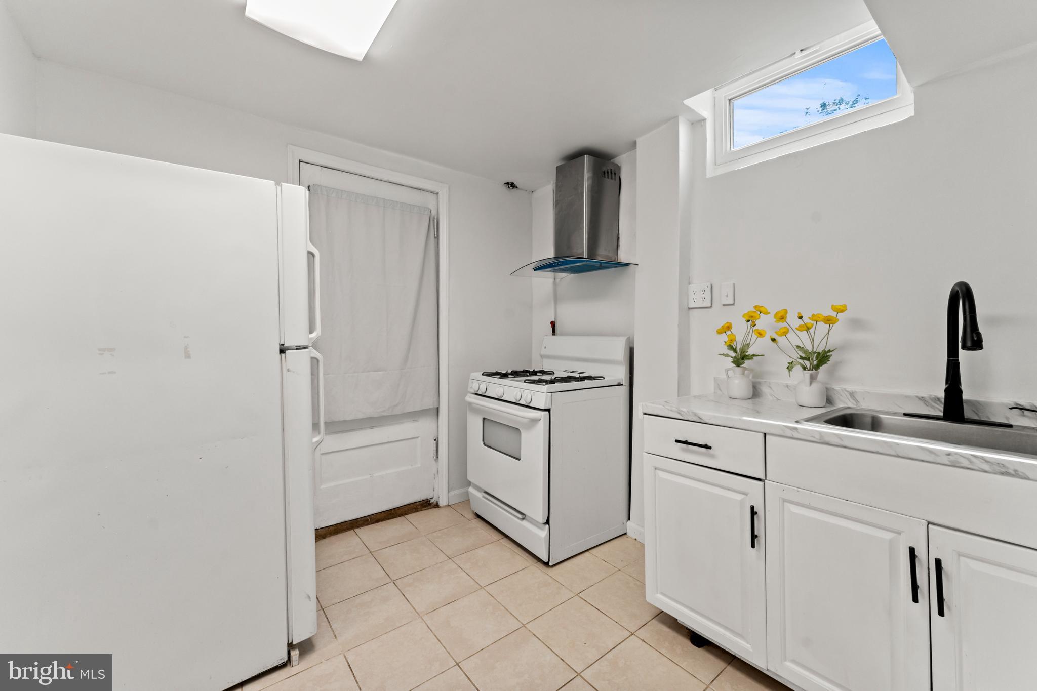 9307 Biltmore Drive Silver Spring, MD 20901 - Photo 22 of 33 a kitchen with white cabinets and white appliances