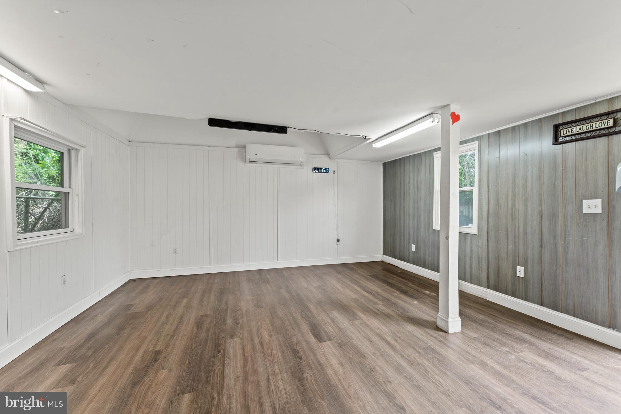9307 Biltmore Drive Silver Spring, MD 20901 - Photo 26 of 33 a view of an empty room with wooden floor and a window