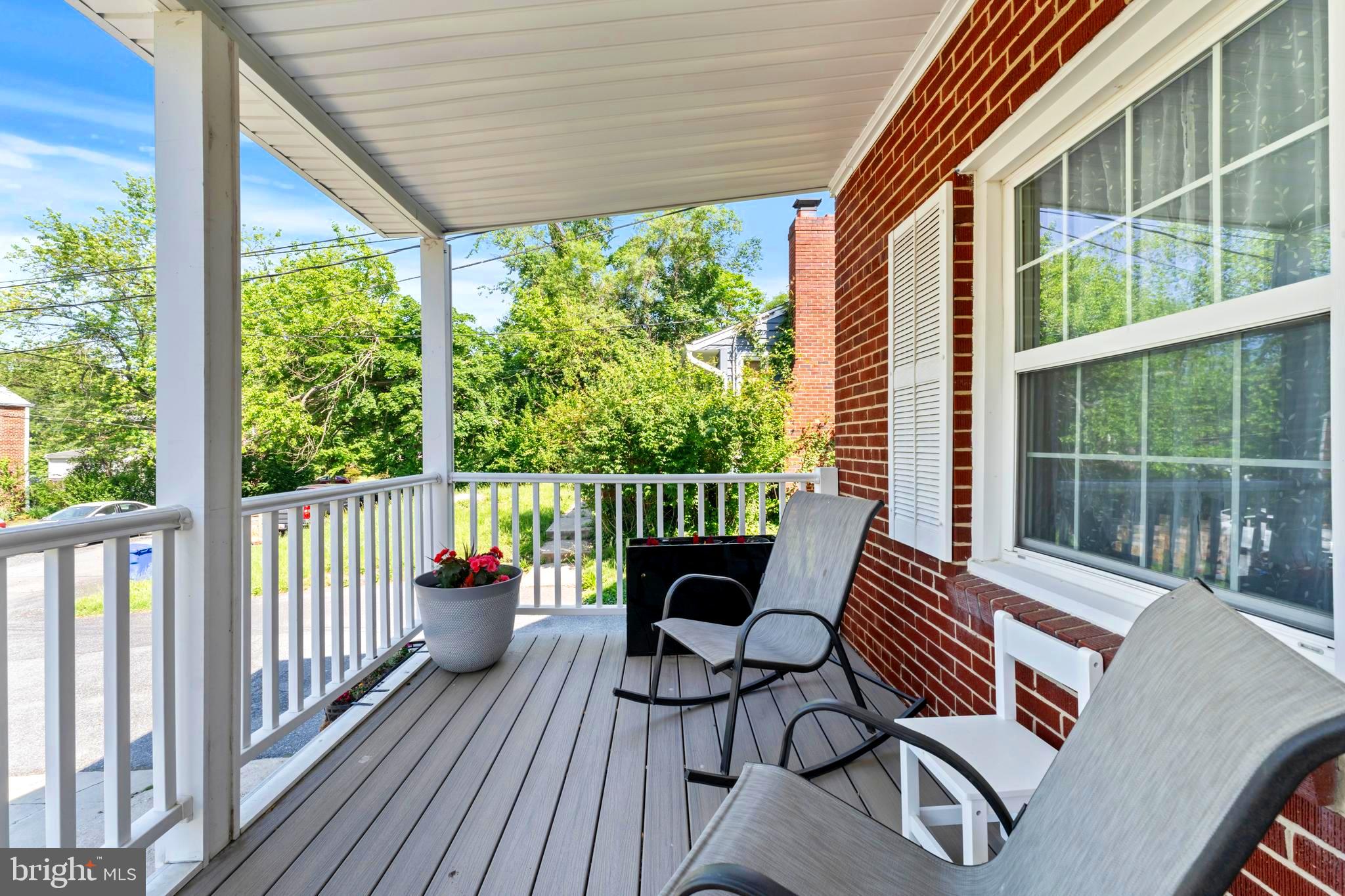 9307 Biltmore Drive Silver Spring, MD 20901 - Photo 3 of 33 a balcony with wooden floor and outdoor seating