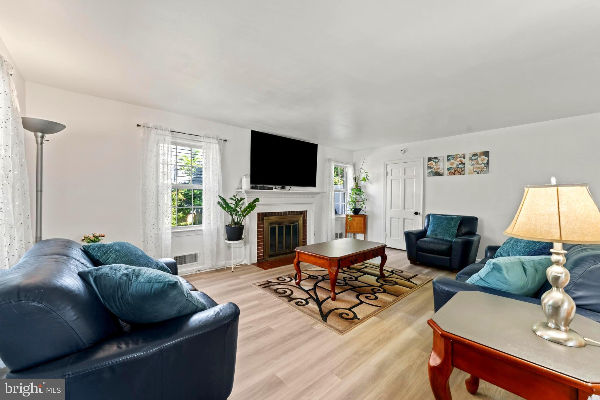 9307 Biltmore Drive Silver Spring, MD 20901 - Photo 4 of 33 a living room with furniture a fireplace and a flat screen tv
