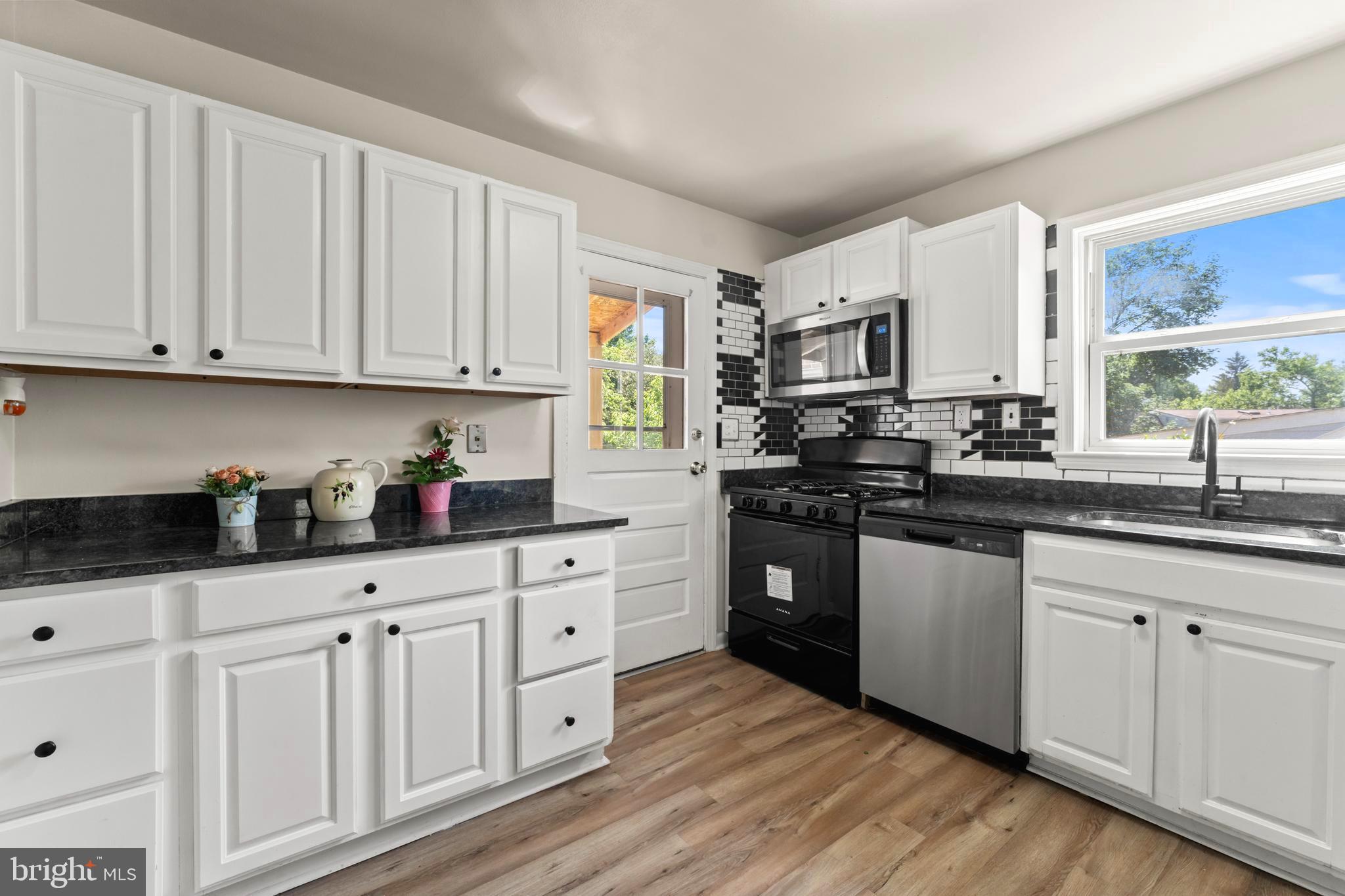 9307 Biltmore Drive Silver Spring, MD 20901 - Photo 8 of 33 a kitchen with granite countertop white cabinets and white appliances