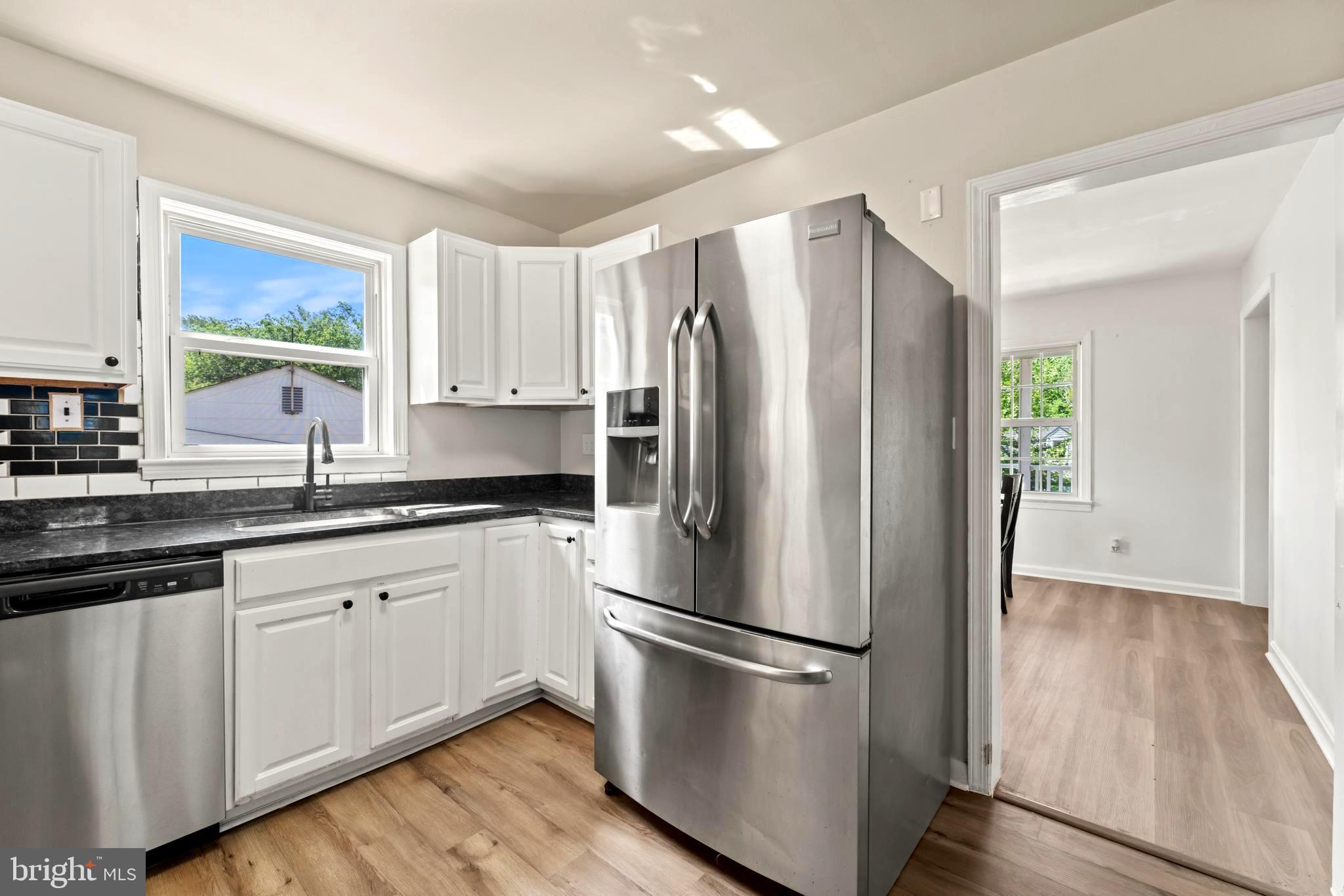 9307 Biltmore Drive Silver Spring, MD 20901 - Photo 9 of 33 a kitchen with stainless steel appliances a refrigerator sink and cabinets