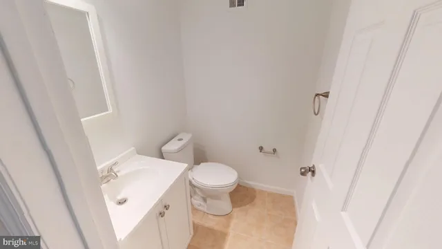 a white toilet sitting next to a white sink