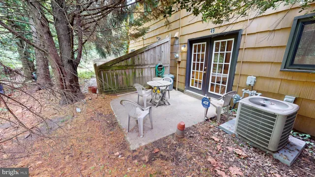 a view of a patio with a table chairs and backyard