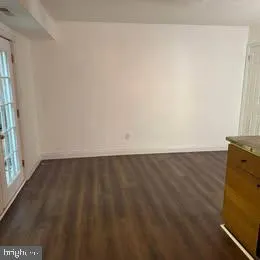 a kitchen with granite countertop a refrigerator and a sink
