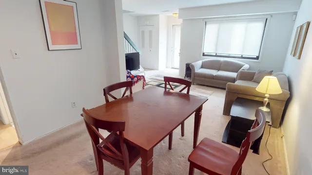 a dining room with furniture and wooden floor