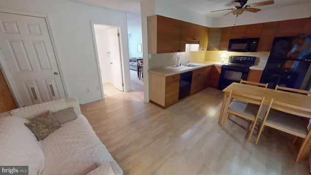 a kitchen with granite countertop a sink cabinets and wooden floor