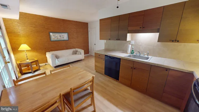 a kitchen with a sink cabinets and wooden floor