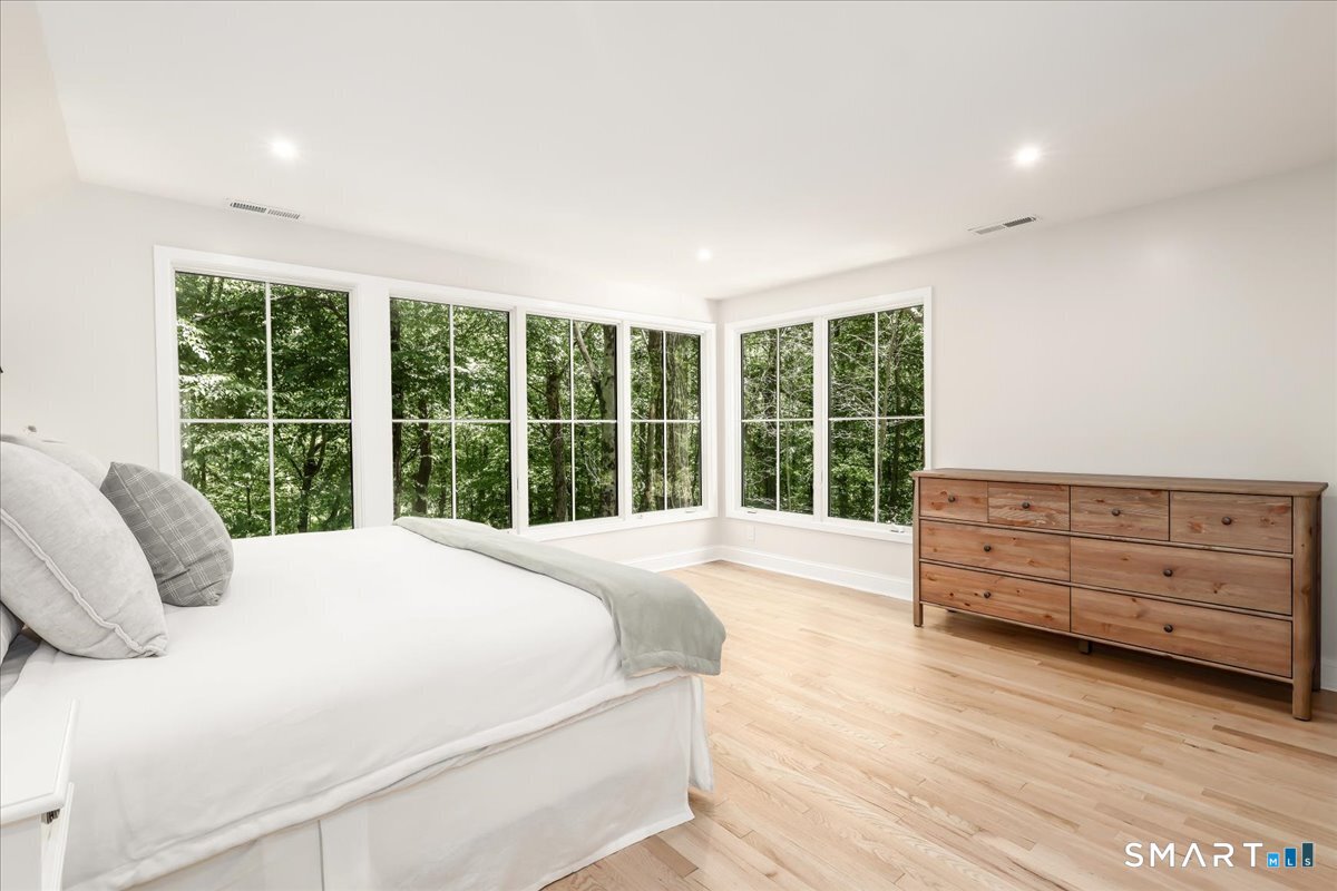 256 Wilton Road East Ridgefield, CT 06877 - Photo 15 of 40 a bedroom with a bed and a large window