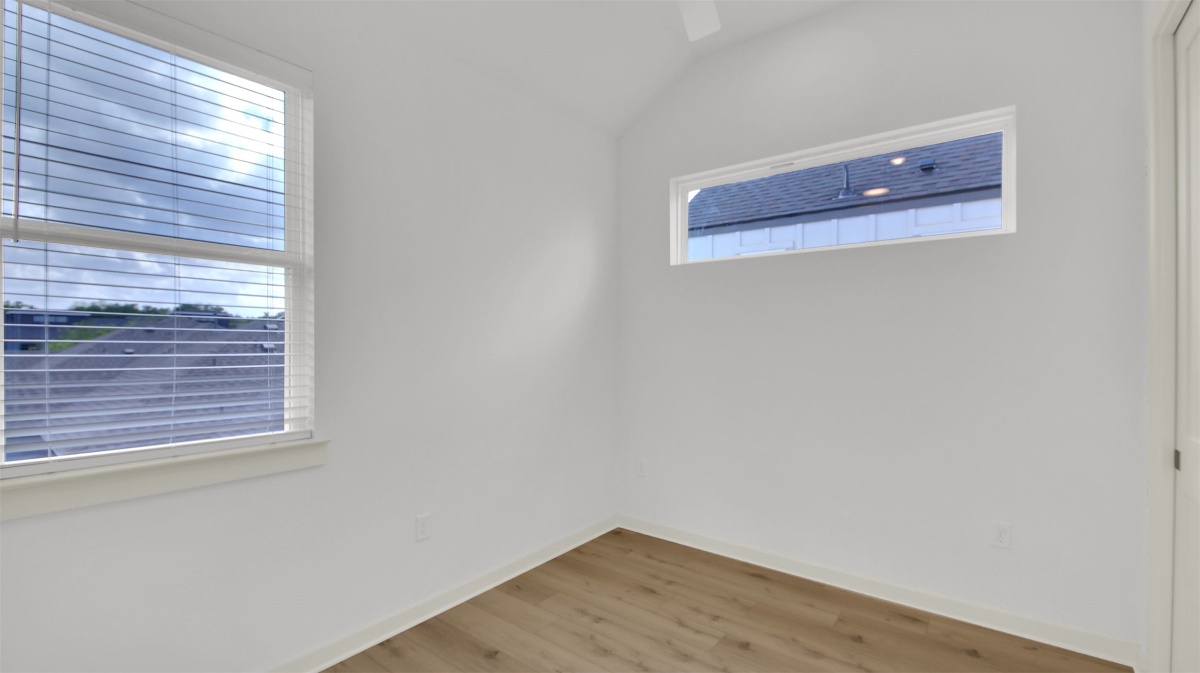 7208 Providence Avenue, Unit 1 Austin, TX 78752 - Photo 22 of 26 The room features light-colored flooring, white walls, and a window with blinds