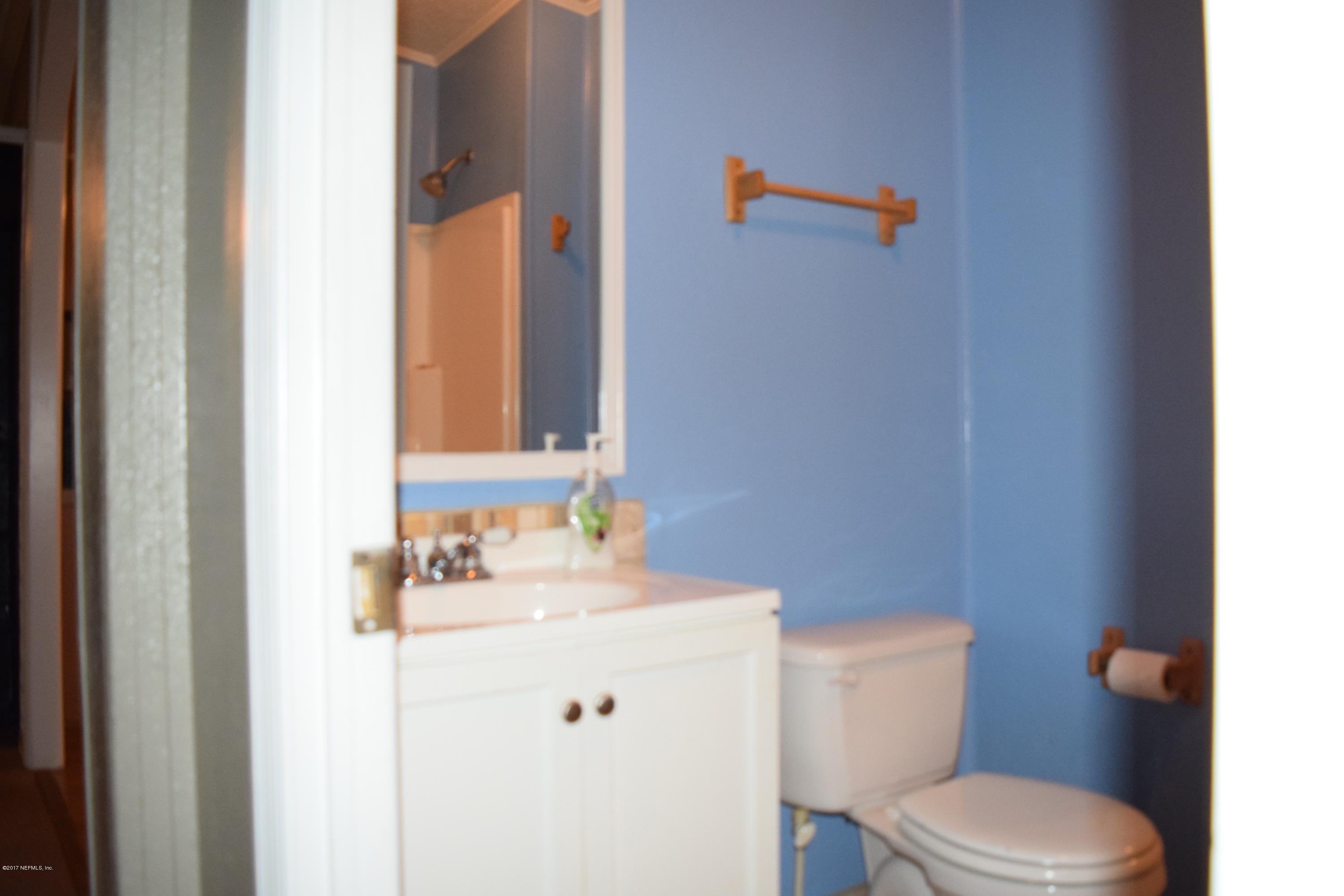 45016 Musslewhite Road Callahan, FL 32011 - Photo 18 of 23 a bathroom with a sink vanity mirror and toilet
