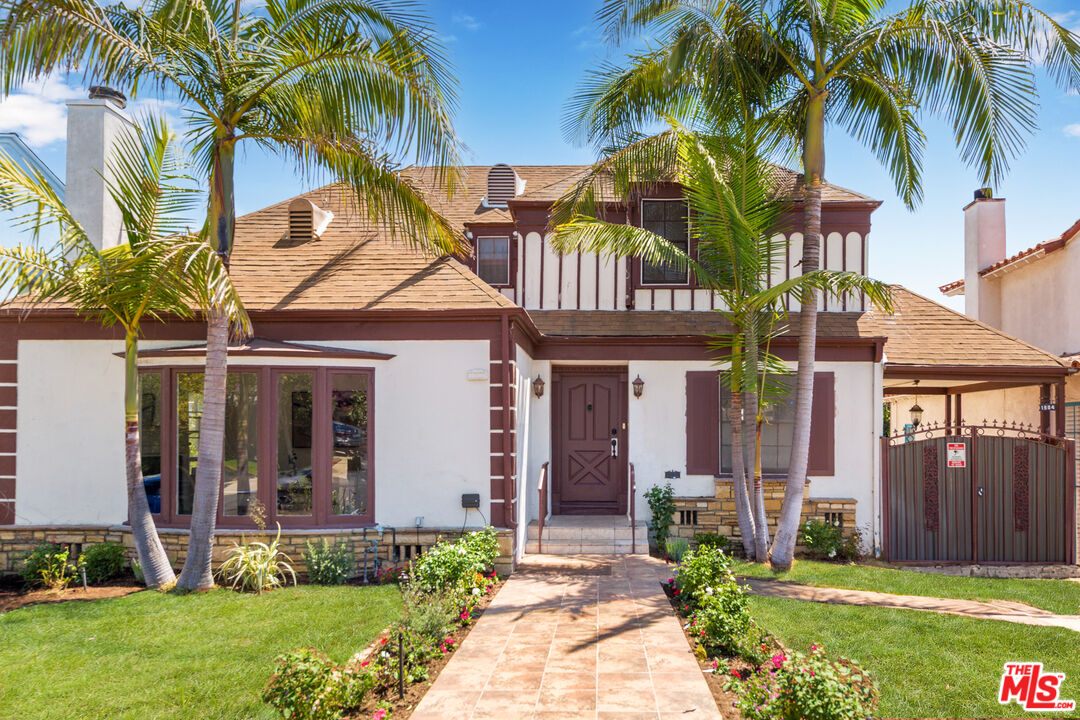 1904 Preuss Road Los Angeles, CA 90034 - Photo 1 of 32 a front view of a house with a garden