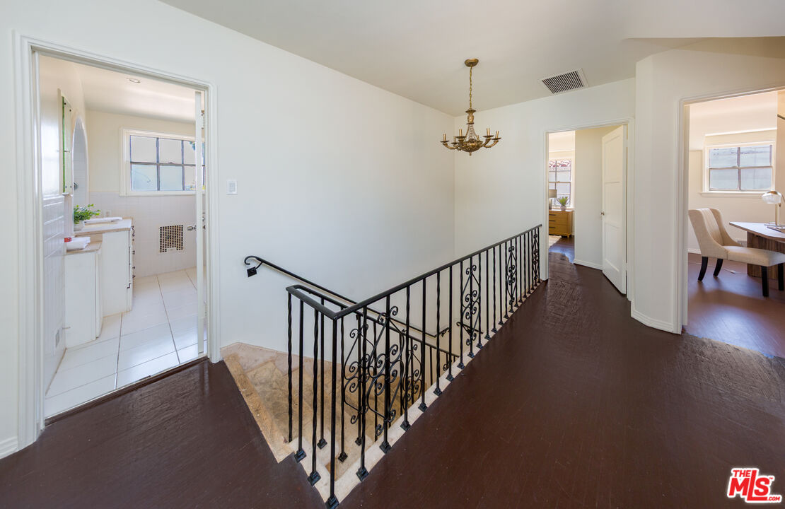 1904 Preuss Road Los Angeles, CA 90034 - Photo 15 of 32 a view of a hallway with wooden floor and stairs