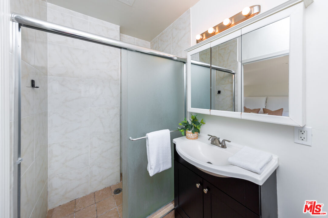 1904 Preuss Road Los Angeles, CA 90034 - Photo 22 of 32 a bathroom with a sink and mirror