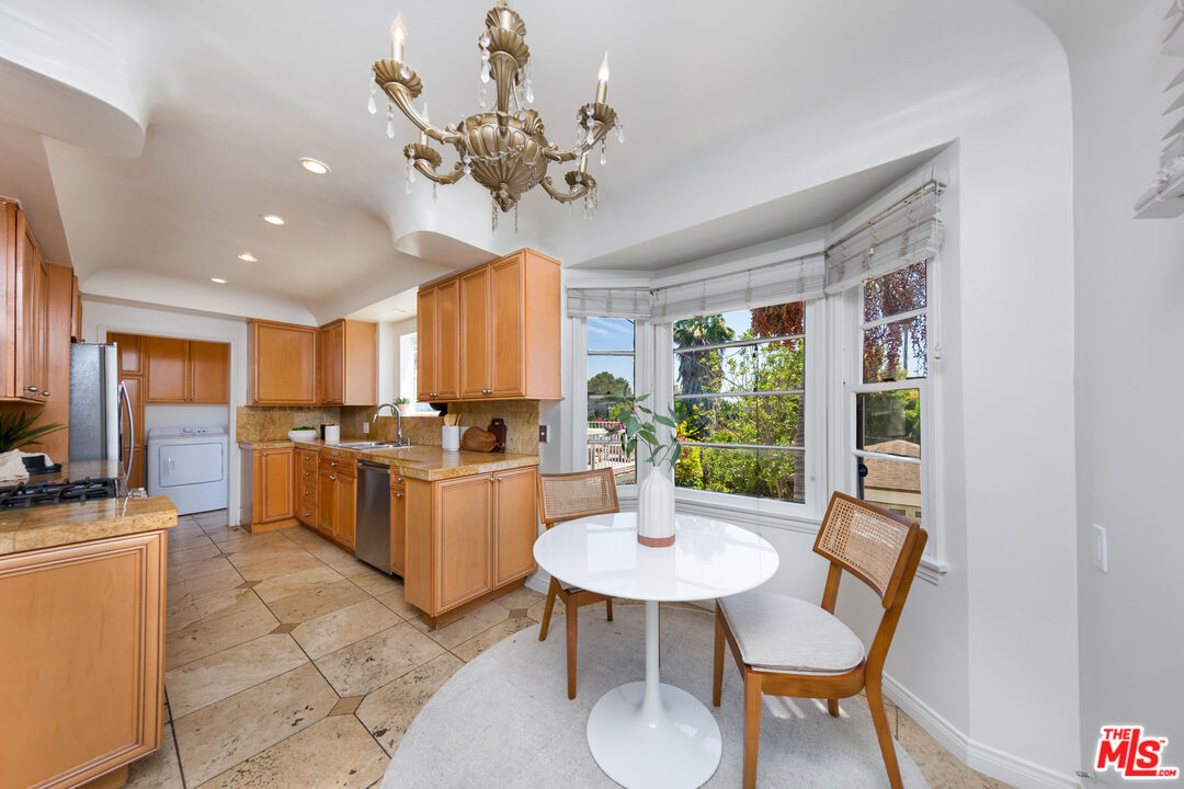 1904 Preuss Road Los Angeles, CA 90034 - Photo 6 of 32 a kitchen with a dining table and chairs