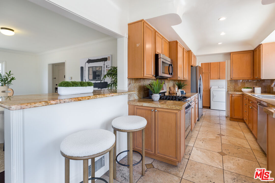 1904 Preuss Road Los Angeles, CA 90034 - Photo 7 of 32 a kitchen with stainless steel appliances granite countertop a sink and a refrigerator