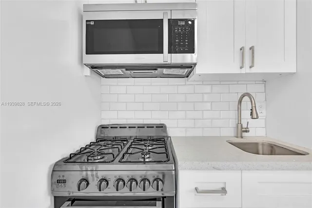 a kitchen with a stove and a sink