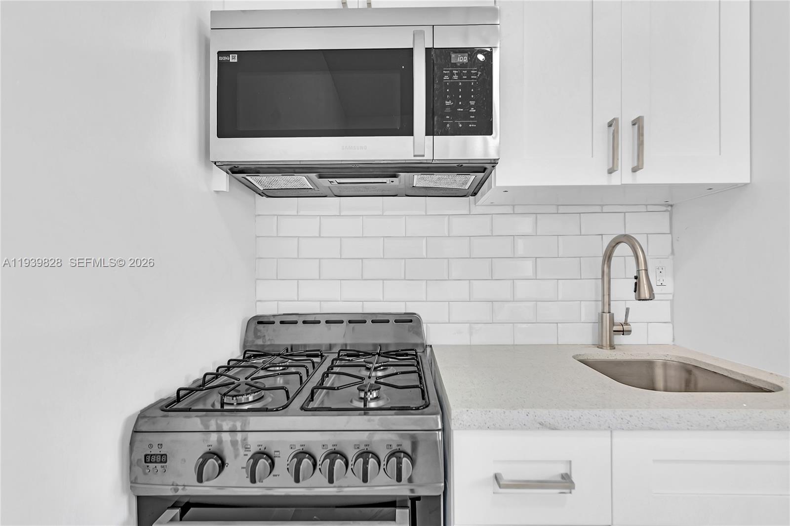 1839 Funston Street, Unit 2 Hollywood, FL 33020 - Photo 12 of 21 a kitchen with a stove and a sink