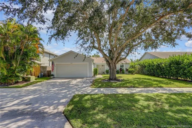 a house is sitting in middle od the grass