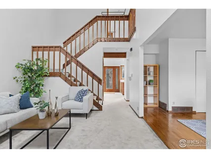 a view of a livingroom with furniture and staircase