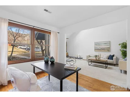 a living room with furniture a table and large window