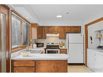 a kitchen with a refrigerator and a sink