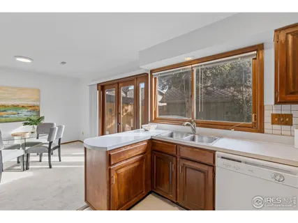 a kitchen with a sink and large window