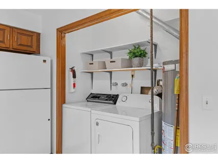 a kitchen with a refrigerator a stove top oven