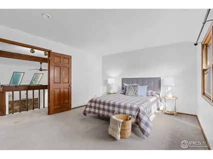 a bedroom with a bed and a lamp with window