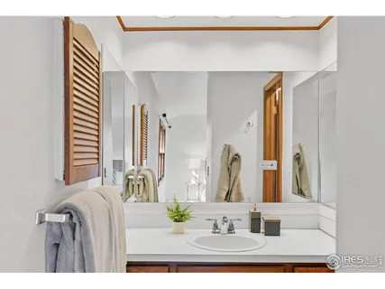 a bathroom with a sink mirror and vanity