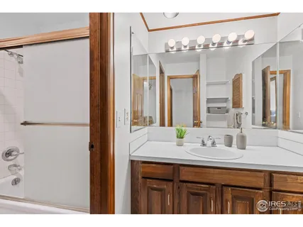 a bathroom with a sink vanity and a mirror