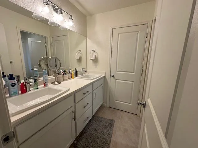 a bathroom with a double vanity sink mirror and