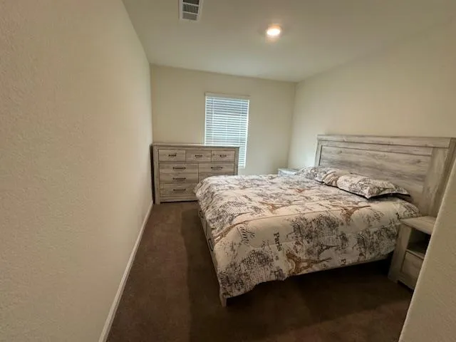 a bed sitting in a bedroom next to a window