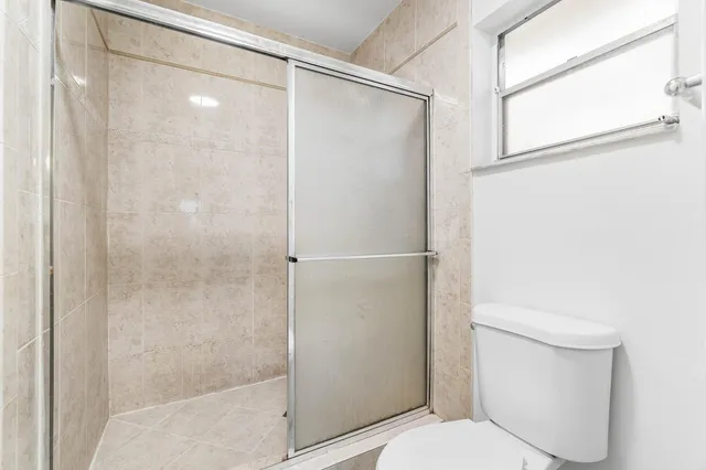 a bathroom with a shower and a toilet