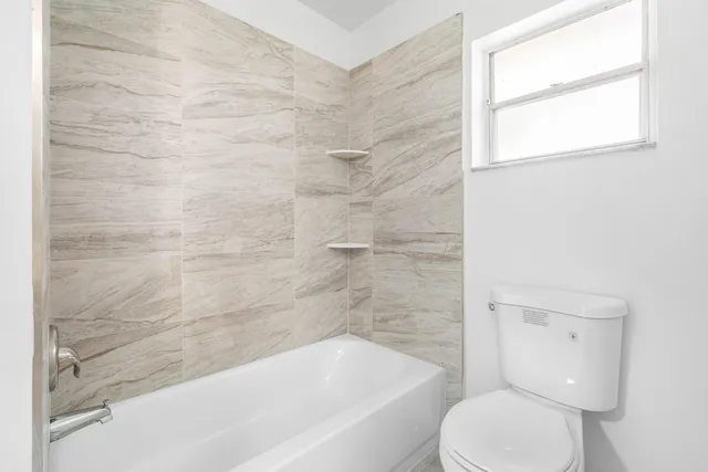 a bathroom with a toilet and a bathtub