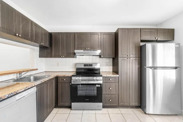 a kitchen with a stove sink and refrigerator