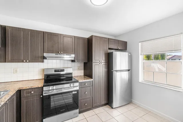 a kitchen with a refrigerator stove and sink