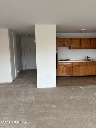 a view of kitchen with stainless steel appliances granite countertop cabinets and wooden floor