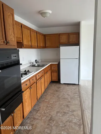 a kitchen with stainless steel appliances a stove a sink and a refrigerator
